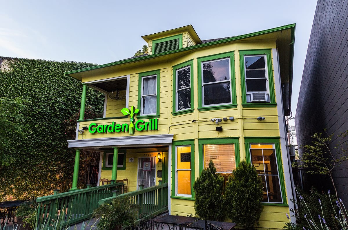 A green-trimmed Victorian house turned restaurant in Midtown